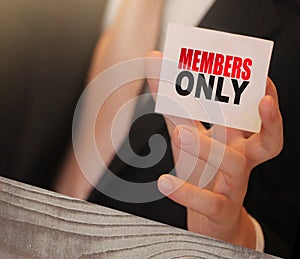 MEMBERS ONLY on a card Businessman holds. VIP clients in business concept