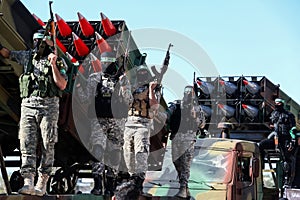 Members of the Ezz-Al Din Al-Qassam Brigades, the armed wing of the Hamas movement, take part in a military parade in a street in
