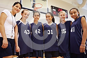 Members Of Female High School Basketball Team With Coach photo