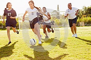 Members Of Female High School Soccer Playing Match