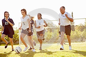 Members Of Female High School Soccer Playing Match