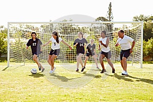 Members Of Female High School Soccer Playing Match