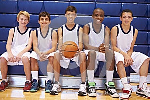 Members Of Male High School Basketball Team On Bench