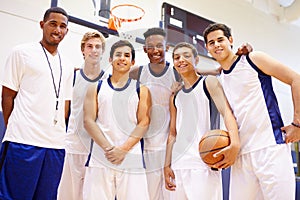 Members Of Male High School Basketball Team With Coach