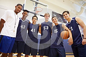 Members Of Male High School Basketball Team With Coach