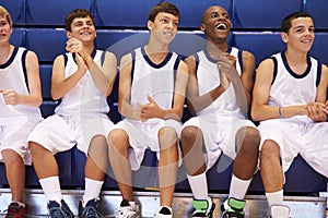 Members Of Male High School Basketball Team Watching Match