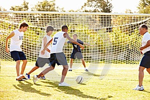 Members Of Male High School Soccer Playing Match