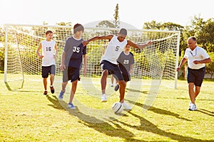 Members Of Male High School Soccer Playing Match