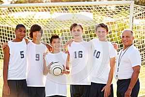 Members Of Male High School Soccer Team With Coach