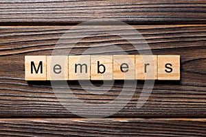 Members word written on wood block. Members text on wooden table for your desing, concept
