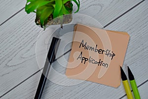 Membership Application write on sticky notes isolated on Wooden Table