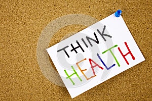 Memo note pinned to a cork notice board as reminder Think Health