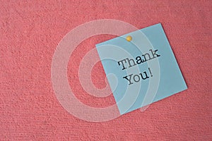 Memo note written with text THANK YOU! isolated on a red background