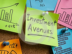 Memo sticks pinned to the board, one with Investment avenues inscription. photo