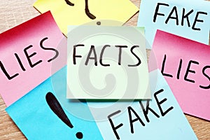 Memo sticks with words Facts, lies and fakes. Modern news.