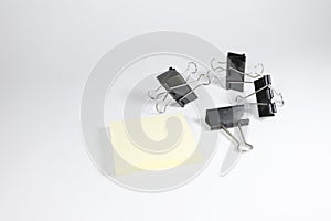 Memopad and binder clips isolated on white background