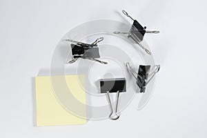 Memopad and binder clips isolated on white background photo
