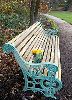 Memorial Bench in a Park with a Bouquet of Roses