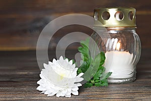 Memorial candle and white flower