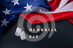 Memorial day concept. American flag and military dog tags on black background. Remember and honor