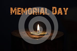 Memorial day, inscription on black background and candle