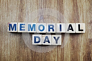 Memorial day word created with cubes alphabet letters on wooden background