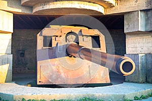 Gun emplacement at Omaha Beach. Bomb shelter with german long-range artillery gun from world war 2 in Longues-sur-Mer in Normandy.