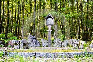 A memorial place of the patron saint on a footpath in the forest. Bavaria, Germany