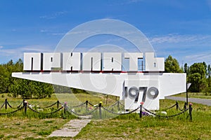 Memorial road sign of dead city Pripyat Ukraine with year of foundation of the city. Chernobyl zone of alienation
