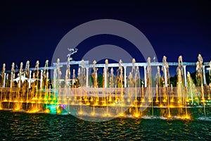 Memorial and rows of fountains with illumination in the Independence Square at summertime in nighttime, Tashkent