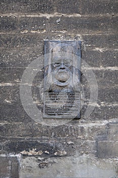 Memorial stone statue portait on the wall of the church