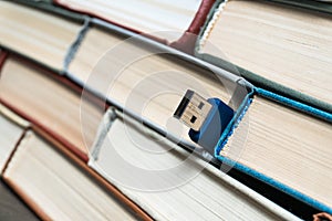 Stack books on wooden background. USB