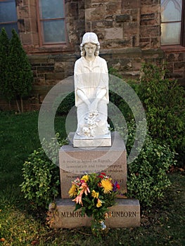 In Memory of the Unborn Statue in front of a Church.