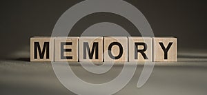 Memory word written with wooden blocks on gray baskground