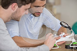 men assembling drone