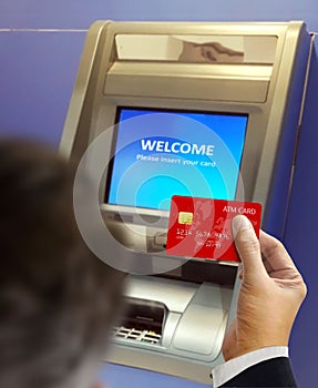 Men at ATM machine doing banking transaction