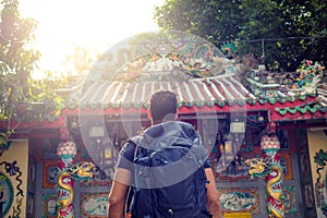 Men backpacker looking at a temple in Bangkok during day, Thailand , Southeast asia .