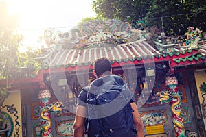 Men backpacker looking at a temple in Bangkok during day, Thailand , Southeast asia .