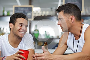 men in bar having conversation
