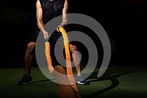 Men with battle rope in functional training fitness gym, Fitness people exercising with battle ropes at gym