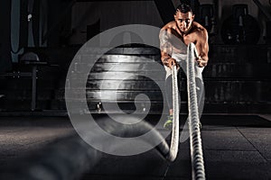 Men with battle ropes exercise