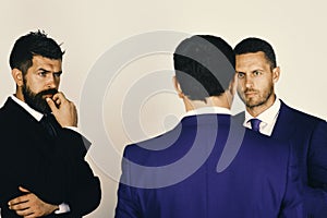 Men with beard and interested faces discuss business. Argument and business concept. CEOs settle disputes on light grey