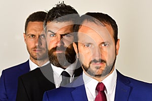 Men with beards and suspicious faces stand for company leadership