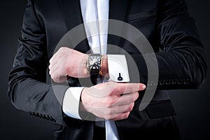 Men in black suit and watch photo