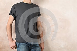 Men in blank grey t-shirt against color background