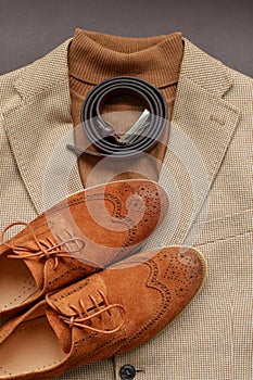 Men brown suede brogue shoes combined with light beige blazer and belt.