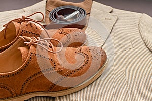 Men brown suede brogue shoes combined with light beige blazer and belt.