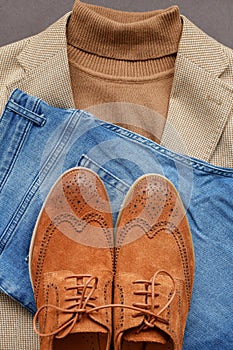 Men brown suede brogue shoes combined with light beige blazer, blue jeans.