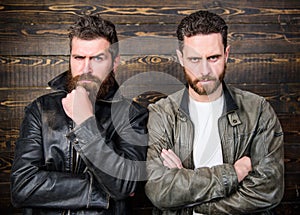 Men brutal bearded hipster posing in fashionable black leather jackets. Leather fashion menswear. Handsome stylish and