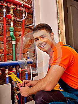 Men builder fixing heating system